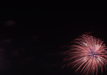 colorful fireworks on the black sky background over-waterの写真素材