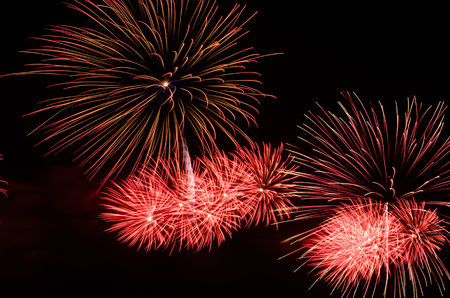 colorful fireworks on the black sky background over-waterの写真素材