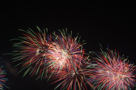 colorful fireworks on the black sky background over-waterの写真素材
