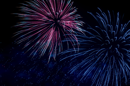 colorful fireworks on the black sky background over-waterの写真素材