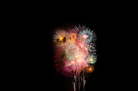 colorful fireworks on the black sky background over-waterの写真素材