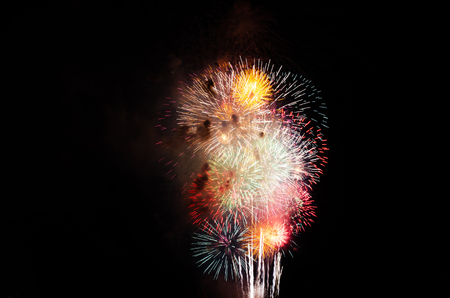 colorful fireworks on the black sky background over-waterの写真素材