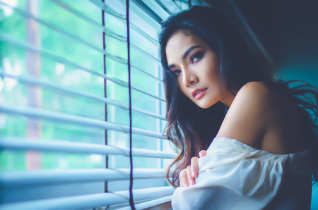 portrait of beside windows looking on photographerの写真素材