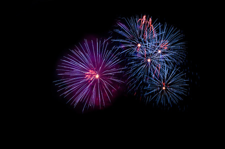 colorful fireworks on the black sky background over-waterの写真素材