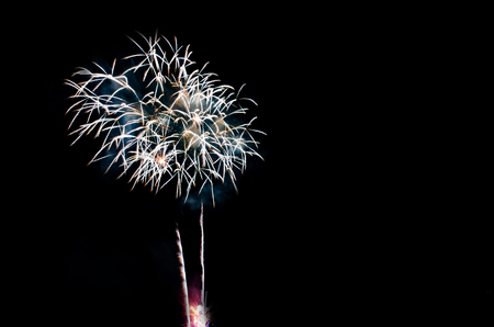 colorful fireworks on the black sky background over-waterの写真素材