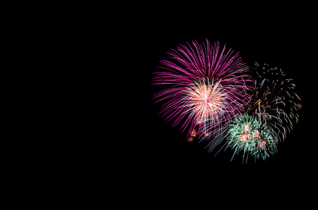 colorful fireworks on the black sky background over-waterの写真素材