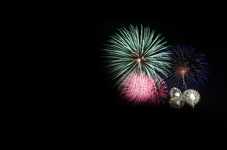 colorful fireworks on the black sky background over-waterの写真素材