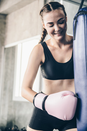 fighter woman fist close up. straight focus on the glove with the rest of the image on blur. concept about sport and peopleの写真素材