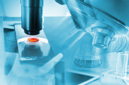 A pipette dropping sample into a test tube,abstract science backgroundの写真素材