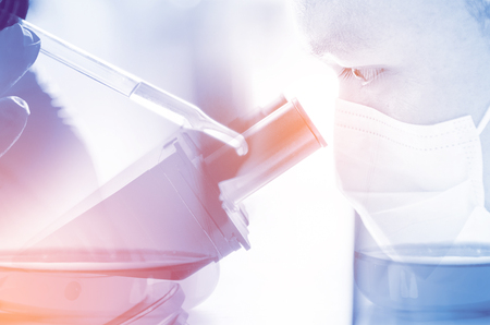 A pipette dropping sample into a test tube,abstract science backgroundの写真素材
