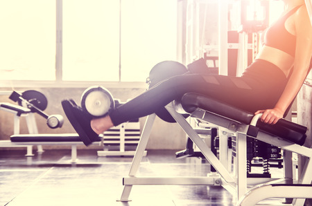 Woman exercise workout in gym fitness on machineの写真素材