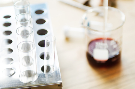 A pipette dropping sample into a test tube,abstract science backgroundの写真素材