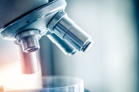 Close-up shot of microscope with metal lens at laboratory. Scientific and healthcare research background.の写真素材