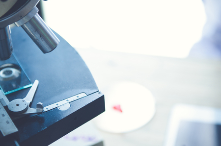 Close-up shot of microscope with metal lens at laboratory. Scientific and healthcare research background.の写真素材