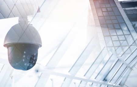 modern CCTV camera on a wall. A foggy day in a city background  image double exposure mock upの写真素材