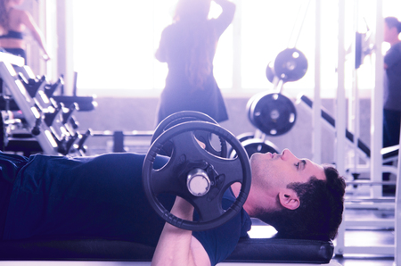 man pickup dumbell in gym . exercise with work out program for healthyの写真素材