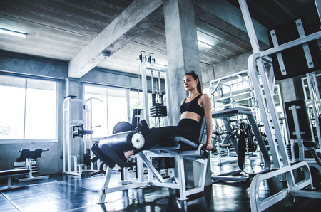 Woman exercise workout in gym fitness on machineの写真素材