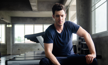 handsome young man sitting in gym . relaxing feel after work out exercise in clubの写真素材