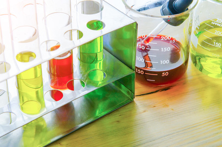 A pipette dropping sample into a test tube,abstract science backgroundの写真素材