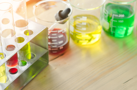 A pipette dropping sample into a test tube,abstract science backgroundの写真素材
