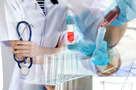 Medical physician doctor woman over laboratory tube blood test and glasswareの写真素材
