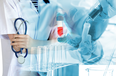 Medical physician doctor woman over laboratory tube blood test and glasswareの写真素材