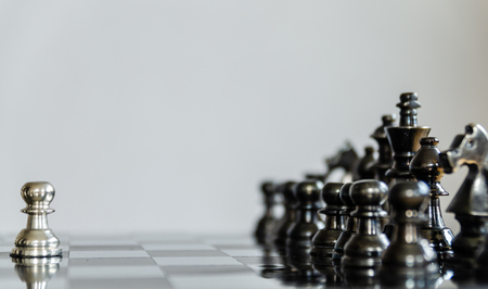 Detail of a hand making the first move in a chess game, moving the pawn one field forward. Selective focusの写真素材