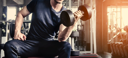 man pickup dumbell in gym . exercise with work out program for healthyの写真素材