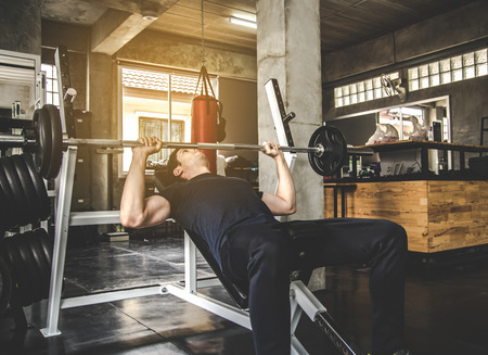man pickup dumbell in gym . exercise with work out program for healthyの写真素材