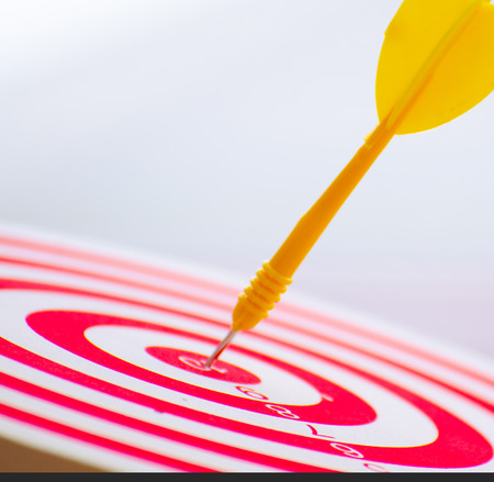 target dart pin on center 10 point dartboard  Marketing concept.の写真素材