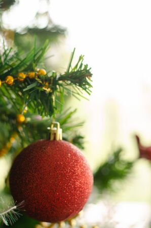 red christmas ball ornament decoration on tree , copyspace for banner text or greetingの写真素材
