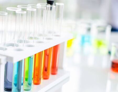 A pipette dropping sample into a test tube,abstract science backgroundの写真素材