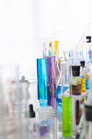 A pipette dropping sample into a test tube,abstract science backgroundの写真素材