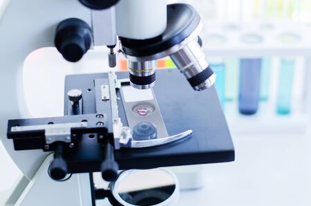 Close-up shot of microscope with metal lens at laboratory. Scientific and healthcare research background.の写真素材