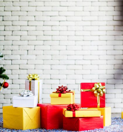 white Christmas gift box  with gold ribbon  and copyspace for your greeting or wishesの写真素材