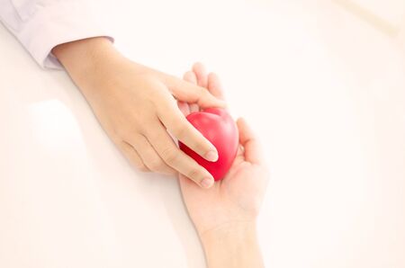 hand of doctor give heart to people  handの写真素材