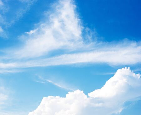 white fluffy clouds in the blue skyの写真素材