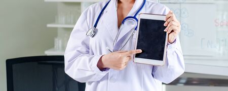 women long hair doctor holding tabletの写真素材