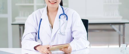 women long hair doctor holding tabletの写真素材