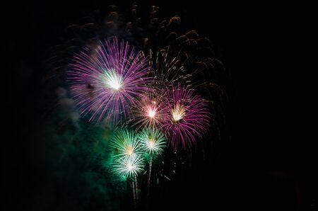 colorful fireworks on the black sky background with free space for text. Celebration and anniversary conceptの写真素材