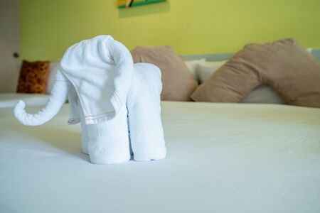 Bath towels on the bed of hotel bedroom
