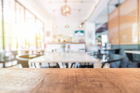 wood table in restaurant and blurred interior decorの写真素材