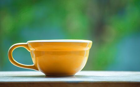 yellow ceramic coffee cup の写真素材