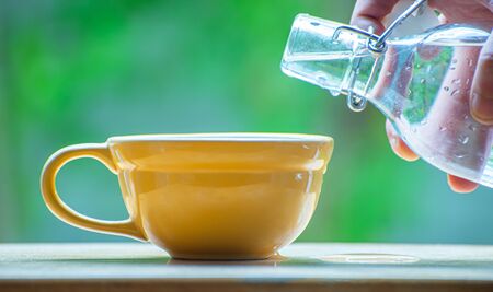 hand Pour water from bottleの写真素材