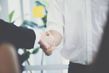 Business people shaking hands, finishing up a meeting ,Successful businessmen handshaking after good deal.の写真素材