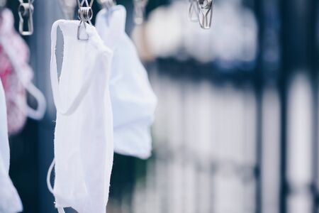 Fabric mask  wash for reuse .White cotton sanitary face mask.Hanging cloth mask.の写真素材