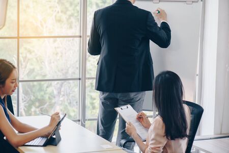 business,  and office concept business team with flip board in office discussingの写真素材