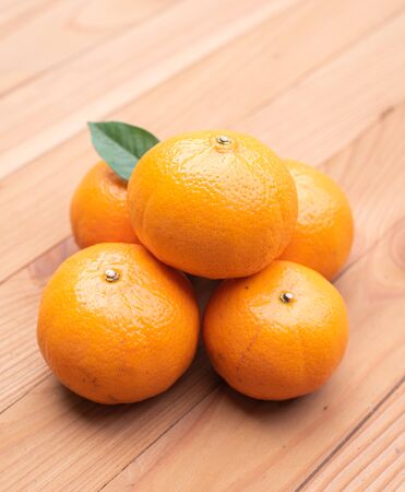orange on wood backgroundの写真素材