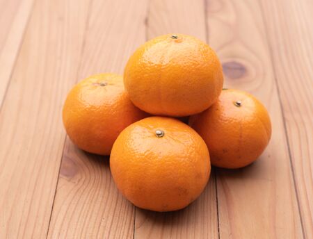 orange on wood backgroundの写真素材