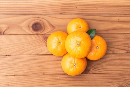 orange on wood backgroundの写真素材